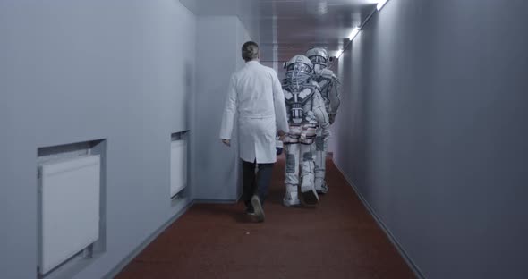 Astronauts Walking Down Corridor alt