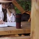 Young Girl In Hat A Tourist Sits In Campsite Resting Studying Map To Plan Further Progress A Tourist - VideoHive Item for Sale