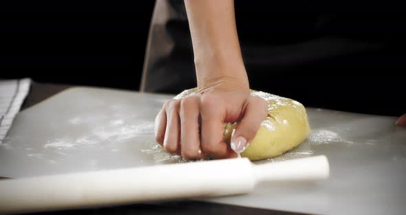 Women's Hands Knead the Dough for Shortbread Cookies on a Silicone Mat