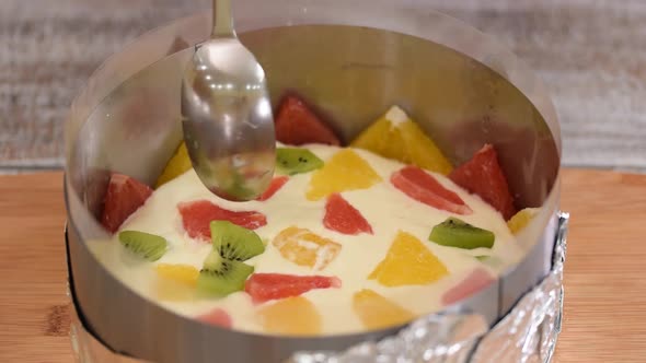 Girl Making Fruit Mousse Cake in the Kitchen