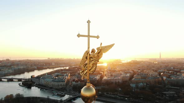 Flying Around an Angel on Spire of Peter and Paul Fortress at Sunset, Close-up. Panorama of St alt