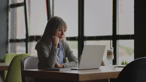 Thoughtful Concerned Chinese Japan Japanese Korean Woman Working on Laptop Computer Looking Away alt