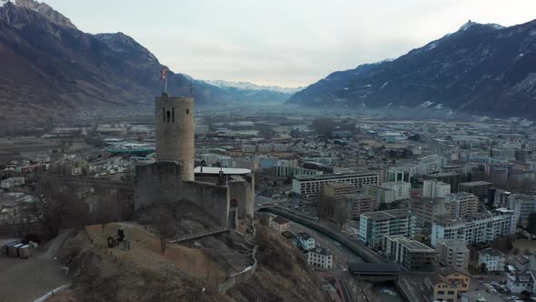 Drone flying past old castle and revealing a busy modern city alt