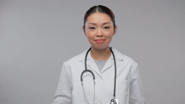 Happy Asian Female Doctor Having Video Call alt
