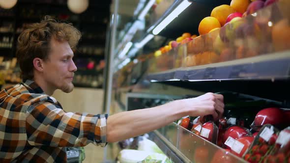 A Caucasian Man in Plaid Shirt Shopping for Fruits and Vegetables in Produce Department of a Grocery alt