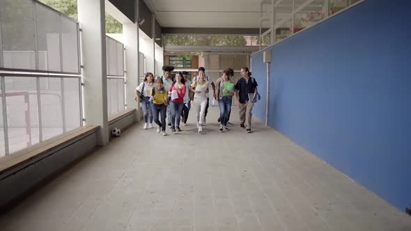 Slow Motion of Group of Students Running Out of the Classroom at the End of Classes alt