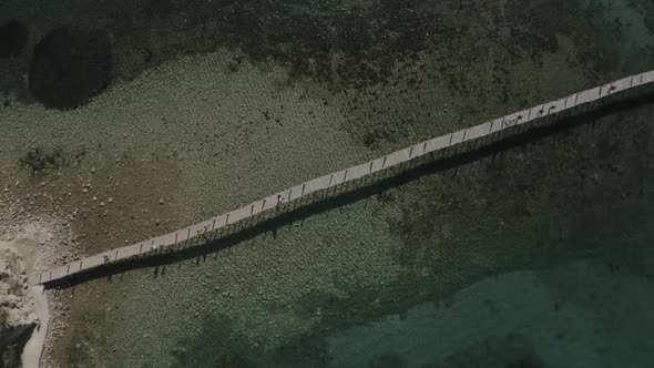 Epic Aerial View Drone Shot of Long Thin Bridge From Shore to Ocean Island