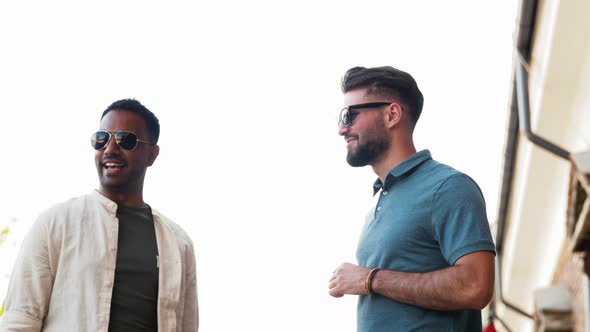Happy Male Friends Drinking Beer at Rooftop Party alt