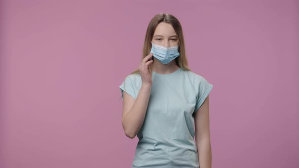 Portrait of a Model with Natural Beauty Removes Protective Medical Mask and Breathes with Relief alt