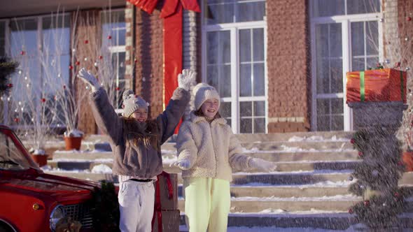Excited Teen Girls Throwing Up Show Decorated Countryside Cottage Background alt