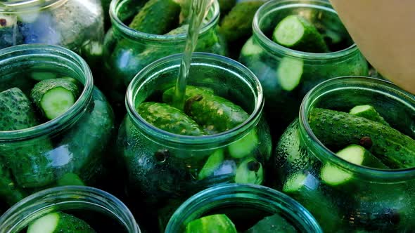 Cucumber Pickle Is Poured Into a Jar alt