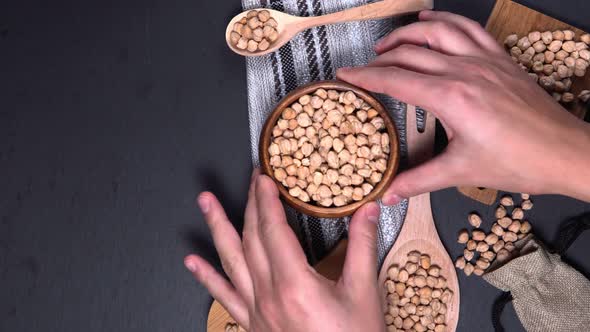 Raw Chickpeas in Bowl on a Dark Background. A View From Above. Vertical Video alt
