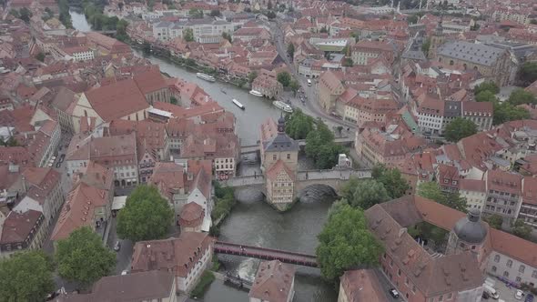 Aerial view of old town hall in Bamberg, Bavaria, Germany. House above river Main. Вridge, boats 