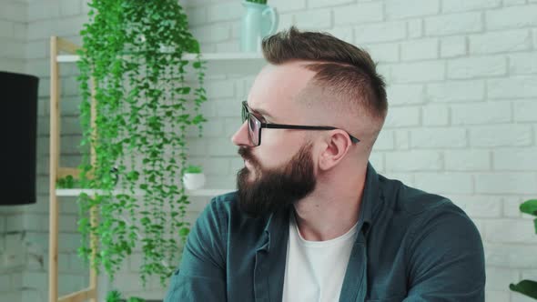 Portrait of a Young Man Resting at Home and Thinking About the Future alt