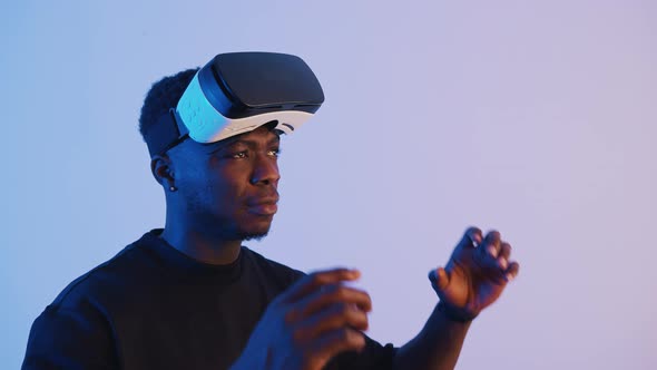 AfricanAmerican Guy Putting on Virtual Reality Glasses alt