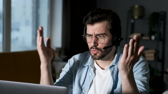 A young Angry Man Solves Problems Communicates Online with Friends or Clients alt