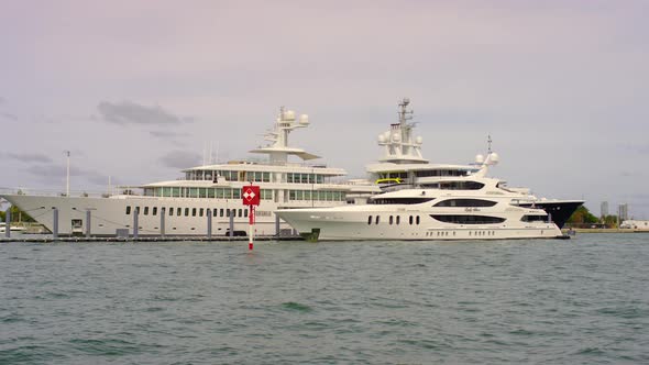 White luxurious yachts in the bay alt