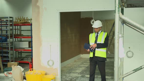 Man using digital tablet at construction site