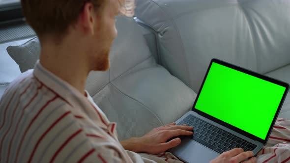 Guy Using Green Laptop Computer Closeup alt