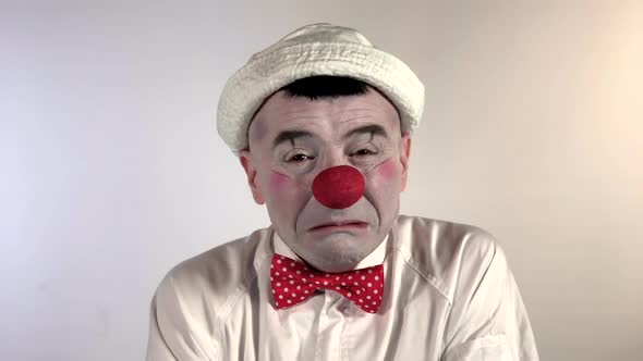 Emoji Clown - Loudly Crying Face. A mime clown wailing and streams two bigs tears flowing from his e alt