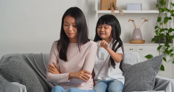 Offended Asian Woman Pretends to Be Angry Because of Her Daughter's Bad Behavior Ignores Little Girl alt