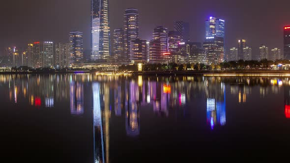 Shenzhen Urban Cityscape China Timelapse at Night with Reflection in Water Pan Up alt
