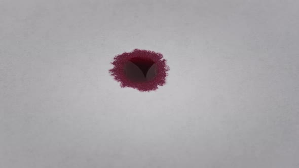 Red Drop of Ink Falls on a White Paper and Absorbed Macro Shot alt