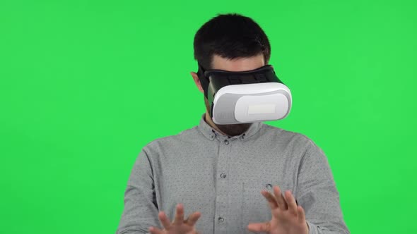 Portrait of Brunette Guy with Virtual Reality Headset or 3d Glasses. Green Screen alt