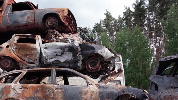 War in Ukraine a Dump of Shot and Burned Cars in Irpin Bucha District alt