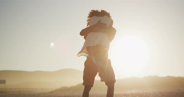 African American couple hugging at the beach alt