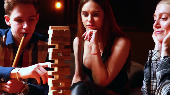 Authentic People Young People Have Fun Playing Board Games at a Table in Cafe alt