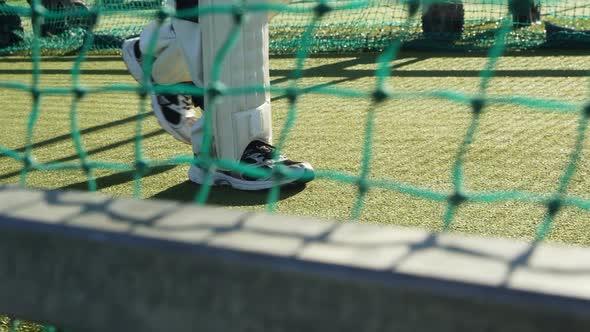 Cricket player walking on the pitch during a practice session alt
