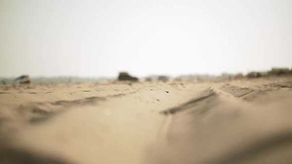 in Slow Motion Perspective View From Ground of Coastal Long Strip of Golden Sand with Camping Tents alt