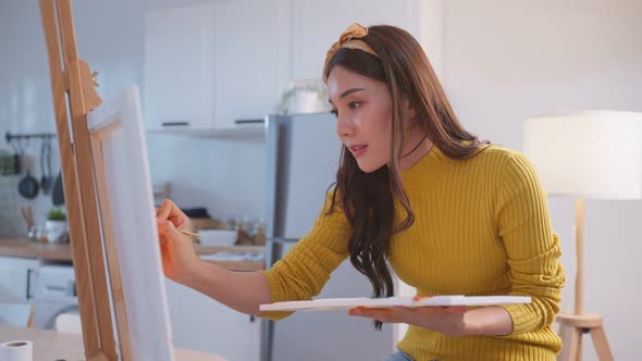 Asian young talented woman draw art picture, creating artwork with watercolor paint and brush. alt