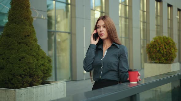 Close Up of Young Woman is Looking Away Against the Background Business Center alt