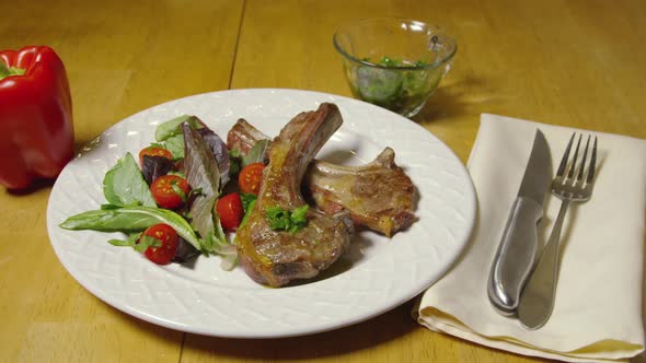 Grilled Lamb Ribs And Salad On A White Plate 16