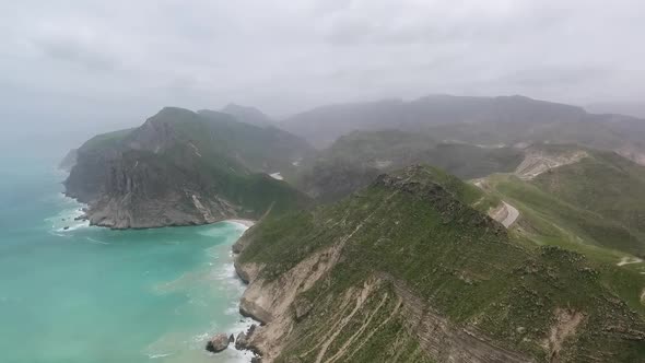 A Drone Shot of The Sea, Waves And Green Grass in the Salalah Governorate, Sultanate of Oman 4 alt