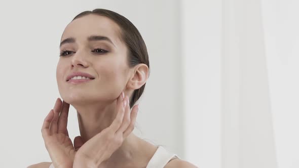 Beauty Care. Attractive Smiling Woman Caressing Face Skin alt