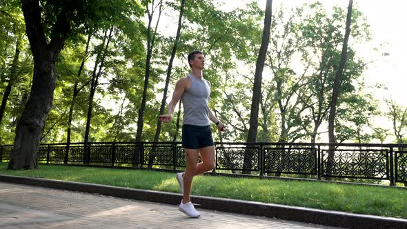 Energy Training of Athletic Guy in Sportswear Jumping on Skipping Rope Sport