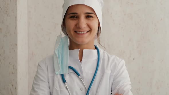 Portrait of a Smiling Female Doctor with Removed Mask alt