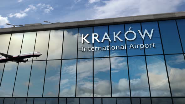 Airplane landing at Krakow, Cracow Poland airport mirrored in terminal alt