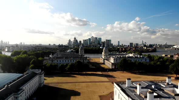 Drone flies over Greenwich Old Royal Naval College towards London downtown on the other side of the alt