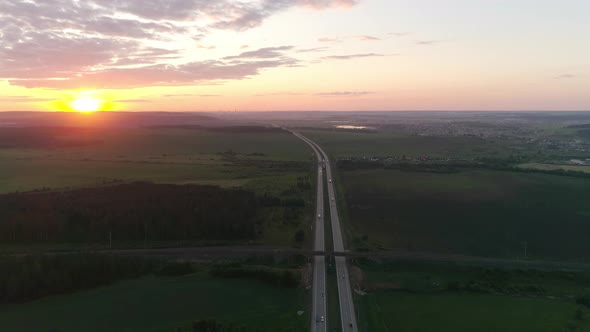 Aerial view of evening highway and fields at sunset 06 alt