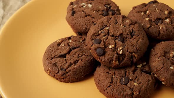 Chocolate cookies on a yellow plate