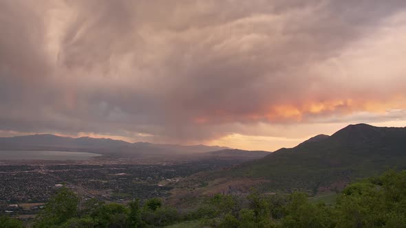 Storm moving over valley during sunrise time lapse in Utah alt