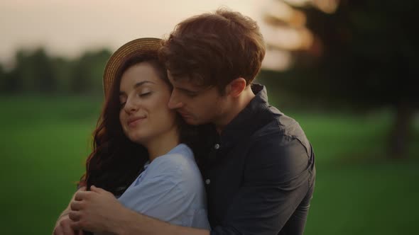 Sensual Couple Expressing Feelings Outdoors. Girl and Guy Spending Date in Park alt