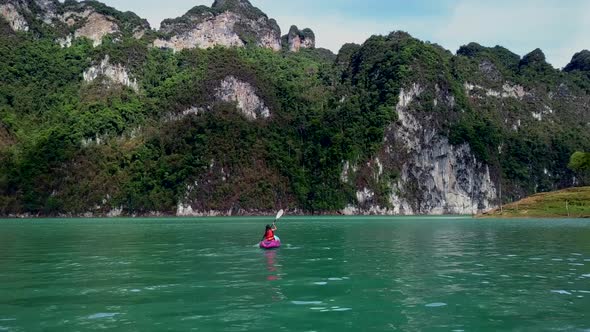 Cute Asian Girl Chilling Kayaking in Cheow Lan Lake Thailand