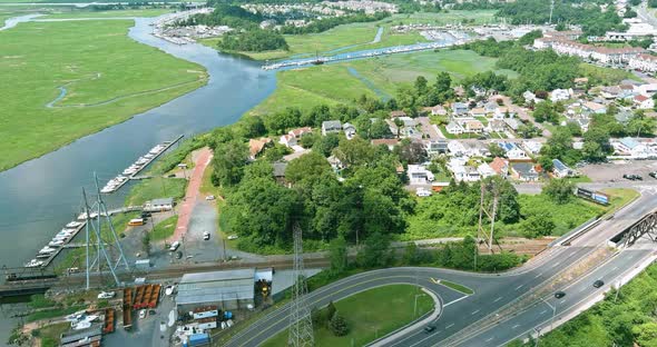Aerial view of motor boats lined up along the dock in a near little seaside american town alt