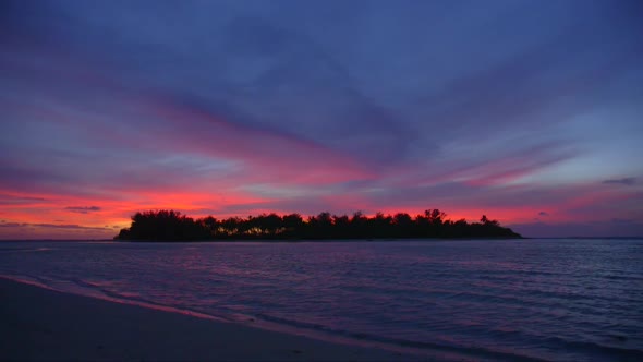 View of a scenic tropical island in Fiji at sunset. alt