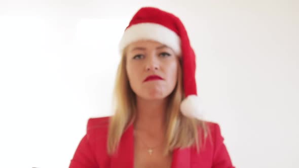 Beautiful Lady Wearing Santa Hat and Holding Christmas Gift in Studio